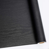 Abyssaly black wood wallpaper roll 24x196 with durable self-adhesive finish for quick furniture refresh.