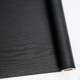 Abyssaly black wood wallpaper roll adds authentic texture to furniture surfaces and hides wear