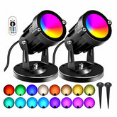 AGDJASA RGBW 8W spotlight on outdoor wall adds garden ambience with color options.