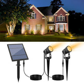 APONUO metal solar spot light highlights garden features at night.