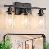 Ascher three-light vanity with clear glass shades for bright, even mirror lighting.