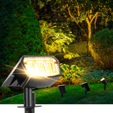 Auderwin 63 LED solar spotlight lighting the front yard path for safe night travel.
