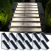 AUDLES LED solar step light emitting a warm glow along outdoor stairs for dusk visibility