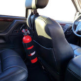 Badass Moto seat-back strap installation secures a fire extinguisher safely.