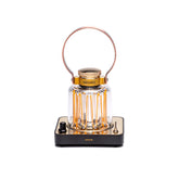 Barebones Block Tower Lantern with brass finish emits warm indoor glow.