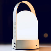 Bask KIN 3.0 cordless lantern on bedside table with warm diffused light
