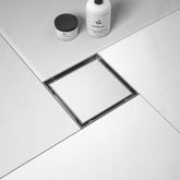 Bernkot square drain with brushed 6-inch outlet for durable bathroom use.