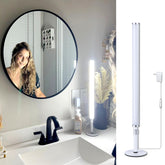 Blikshin LED vanity light over mirror with arc illumination for even makeup application.
