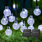 Brightown 2-Pack 72ft solar globe string lights glow over outdoor space.