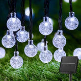 Brightown solar string lights with 60 LEDs glow softly to brighten outdoor evenings.
