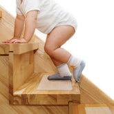 Butizone stair treads on wooden stairs show clear non-slip strip for slip resistance.