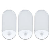 Camelion 3-pack 4-in-1 night light plugged into outlet for safe hallway lighting.