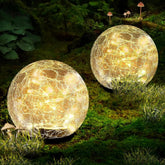 Coroor crackle-glass globe light along a garden path, creating magical outdoor ambiance.