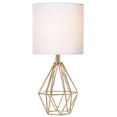 COTULIN gold hollow-base lamp viewed beside the bed for a cozy reading light.