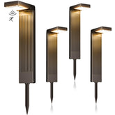 COXSENI Solar Pathway Lights 4Pack emit warm light to welcome guests along a walkway