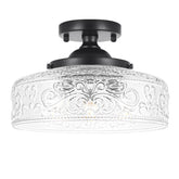Daunton semi flush mount with three clear glass shades and vintage matte black finish.