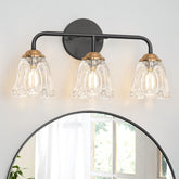 Daunton vintage 3-light vanity light with brushed brass and clear glass shades enhances bathroom ambiance