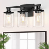DORESshop 17-inch three-light black vanity over mirror with clear glass shades for balanced illumination.