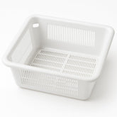 Drain-Net 8.5-inch floor sink basket in use in a busy restaurant kitchen.
