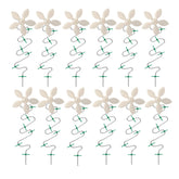 DrainWig shower drain hair catcher with white flower design traps hair while preserving water flow.