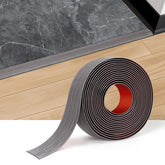 Durteljana gray wood floor-transition strip with plank finish for seamless room transitions and reduced trip hazards.