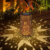 Eandisom hummingbird solar lantern glows warmly in the garden