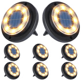 Flacchi solar ground light disk on ground providing even warm illumination along a path.