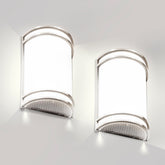 Flynix half-cylinder wall sconce in brushed nickel delivers warm ambient lighting.