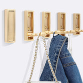 5PCS Foldable Gold Wall Hooks securely hold coats and bags in entryways.