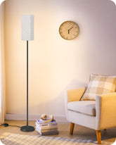 GOEBLESON floor lamp base shows sturdy metal construction for stable placement beside a sofa.