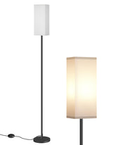 GOEBLESON floor lamp beside a sofa for warm ambient corner lighting.
