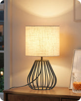 Goebleson small bedside lamp with black cage base for stable nightstand lighting
