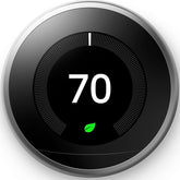 Google Nest Learning Thermostat display on wall showing a bright temperature readout