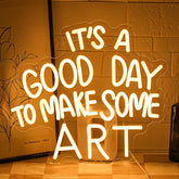 Gyaksjm Good Day neon sign on wall provides warm ambient light for creative spaces.