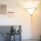 Haultop corner light triangle frame emits soft ambient glow in living room.