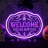 Horseneon Welcome Foolish Mortals sign front-lit for spooky entryway ambiance.