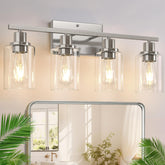 Indoi four-light brushed nickel bathroom fixture with clear glass shades for modern spaces.