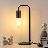 Iporovon industrial table lamp with a sturdy bedside base for stable lighting.