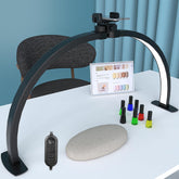 iVict Half Moon Light at nail desk with phone stand for hands-free recording.