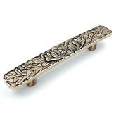 JETLAND bridged drawer pulls in antique brass with a peony motif for durable cabinet updates.