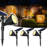 JSOT 600-lumen solar spotlight lighting a garden path at dusk.