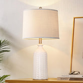 JUNNAI white ceramic lamp base provides stable bedside lighting with a soft glow for cozy bedrooms.