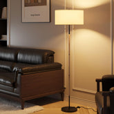 Karjoefar 2-light floor lamp with white fabric shade provides warm ambient lighting.