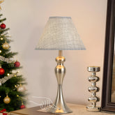 KARTOOSH rechargeable table lamp nickel finish on nightstand provides reading light.