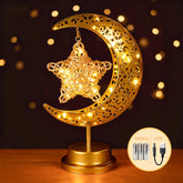 Komothala crescent moon and star lamp in brass provides warm ambient illumination for living spaces.