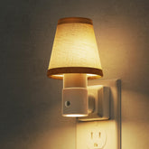 L LOHAS LED night light on wall provides soft illumination for safe nighttime navigation.