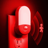 L LOHAS LED Red Night Light plugs into outlet with a gentle glow for safe night trips.