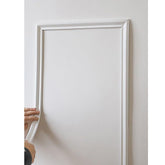LaRolls peel and stick molding trim on a wall corner for quick home upgrade.