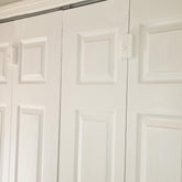 LatchSmart bifold lock mounted on door for easy child safety