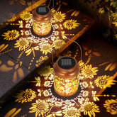 Lazzgan solar sunflower lantern hanging in a tree projecting butterfly patterns